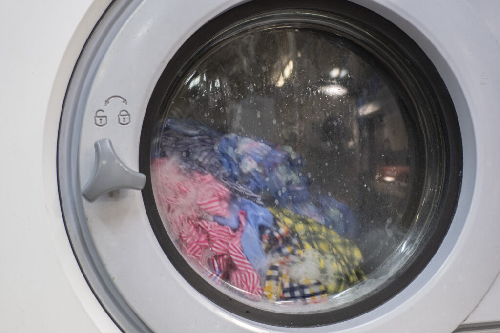 a photo of a washing machine washing clothes
