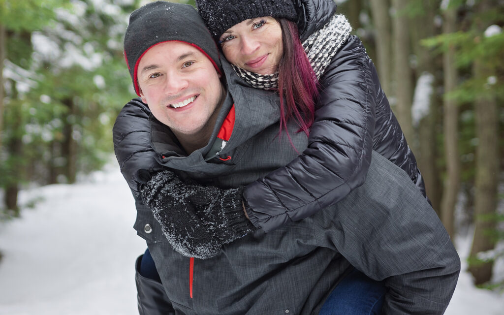 a photo of a couple on a hiking trail wearing winter jackets