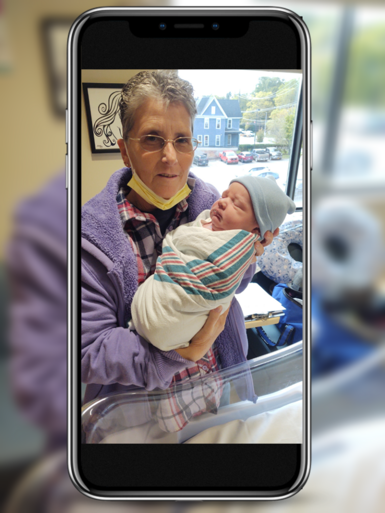 A photo of our HR & Admin Assistant, Peggy Rothwell, holding her grandchild.