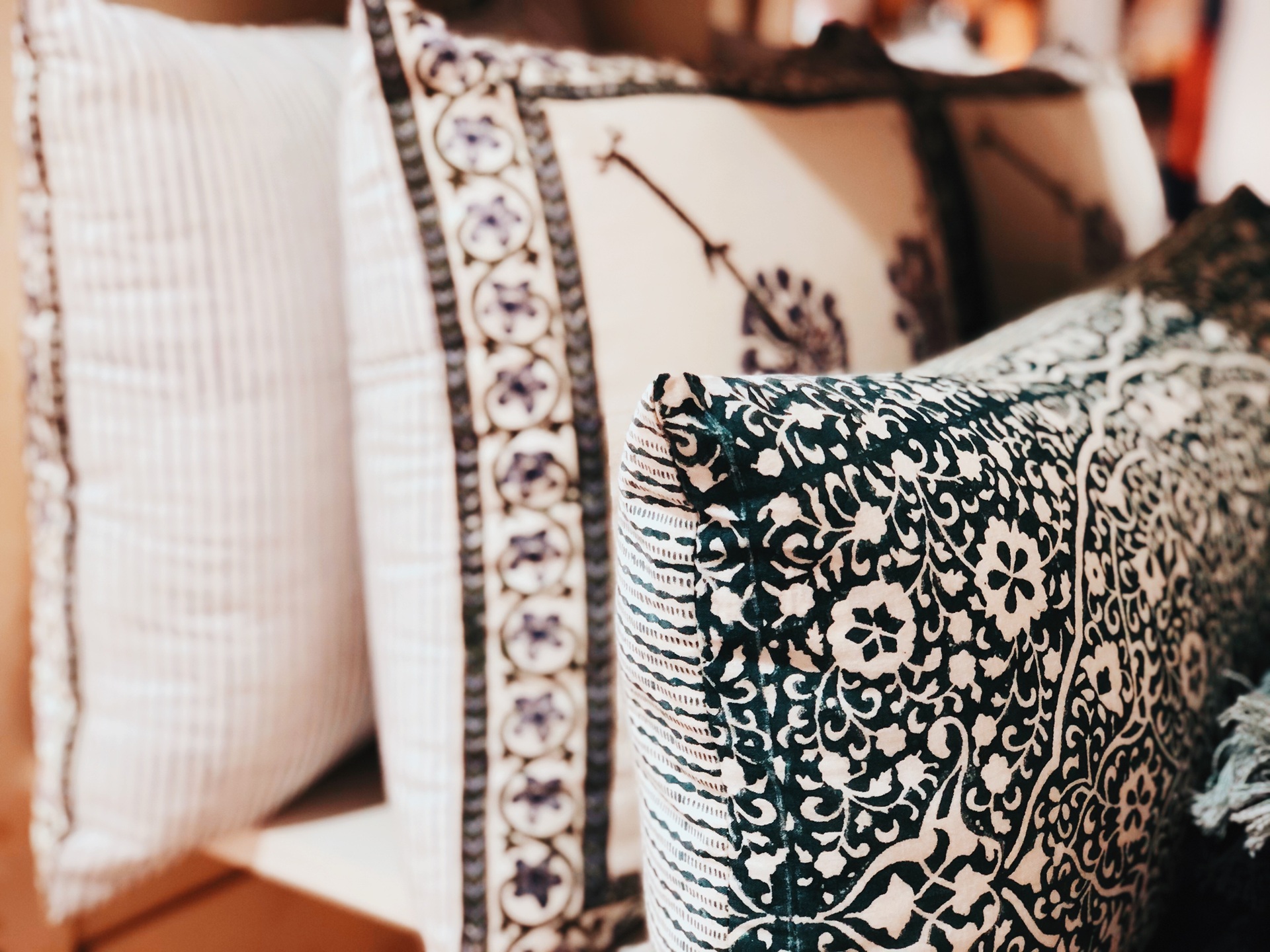 Three decorative pillows with patterned covers in white, blue, and black tones are arranged in a row, showing detailed fabric textures and designs. Three decorative pillows with patterned covers in white, blue, and black tones are arranged in a row, showing detailed fabric textures and designs.