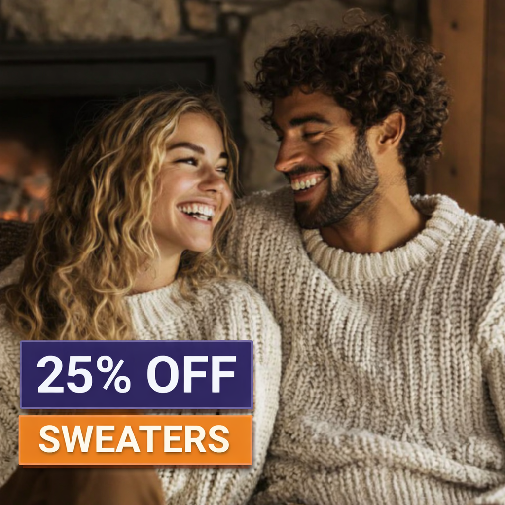 A smiling couple in cream sweaters sits by a fireplace. Text overlay reads “25% OFF SWEATERS.” Perfect for cozy nights or those searching for jobs in Buffalo NY.